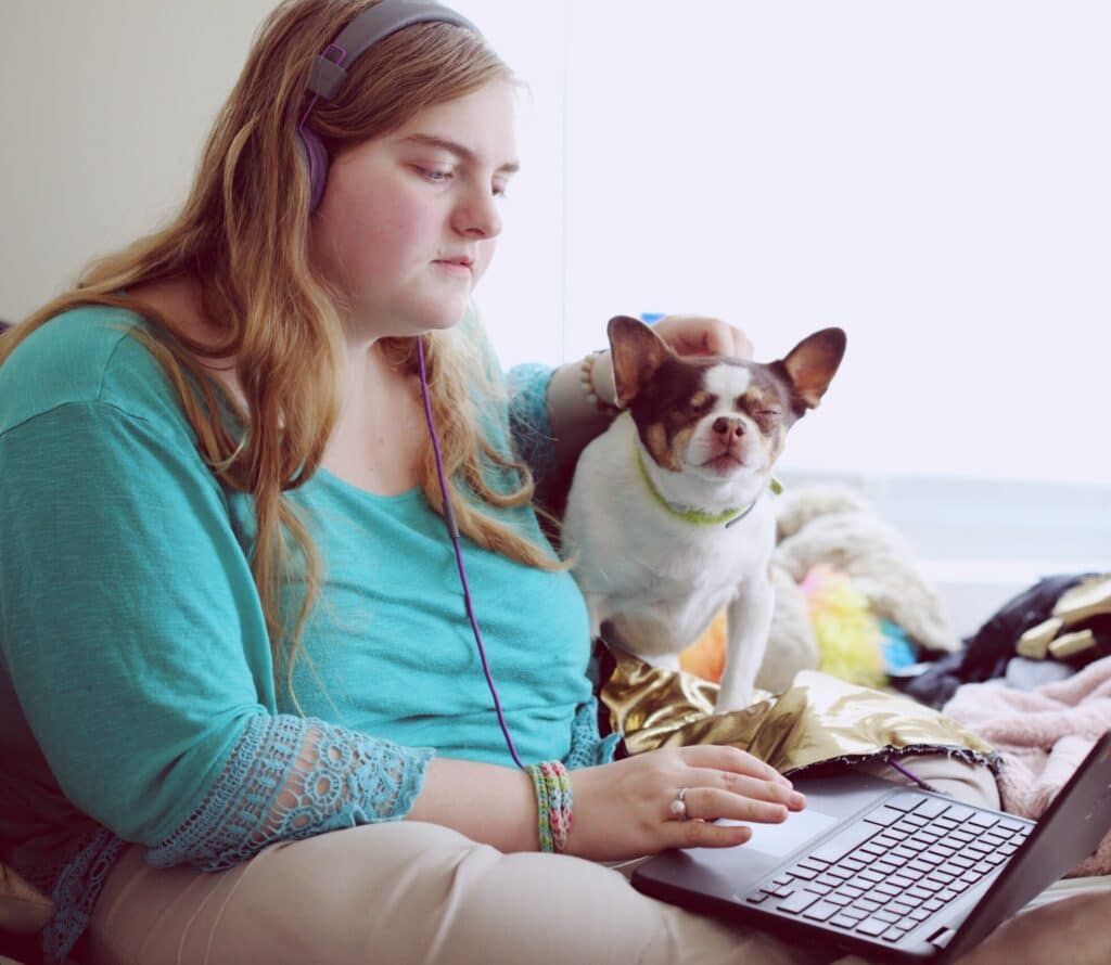 A 19-year-old woman with Autism and other learning disabilities using her laptop to study remotely.