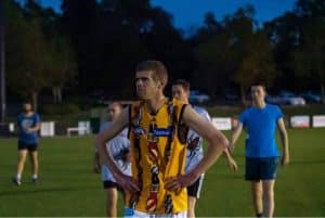 australian+inclusive+footy+players+playing+evening+game+yellow+uniform+with+blue+white+opponents